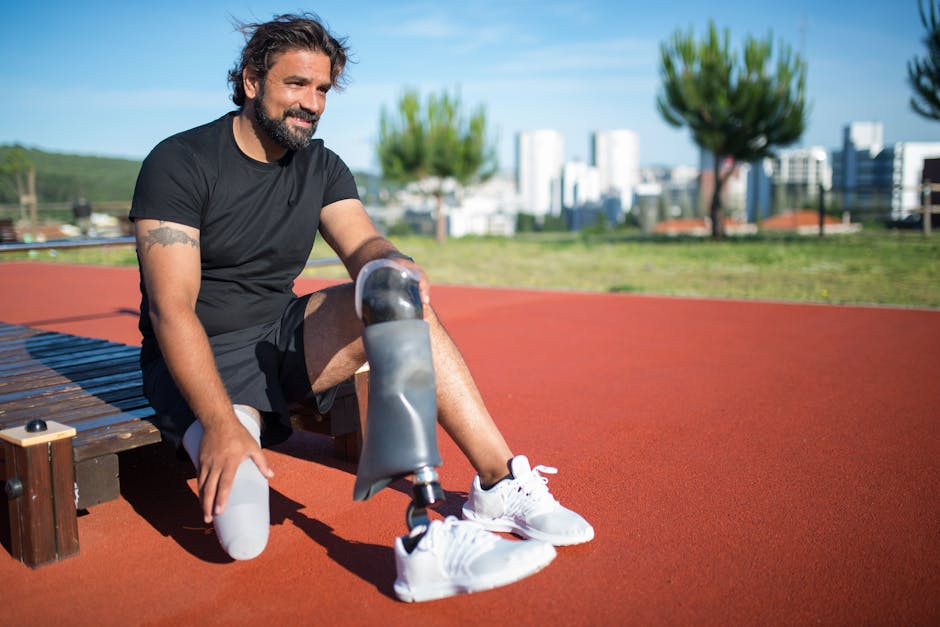Man with prosthetic leg sitting on running track in Lisbon, Portugal.