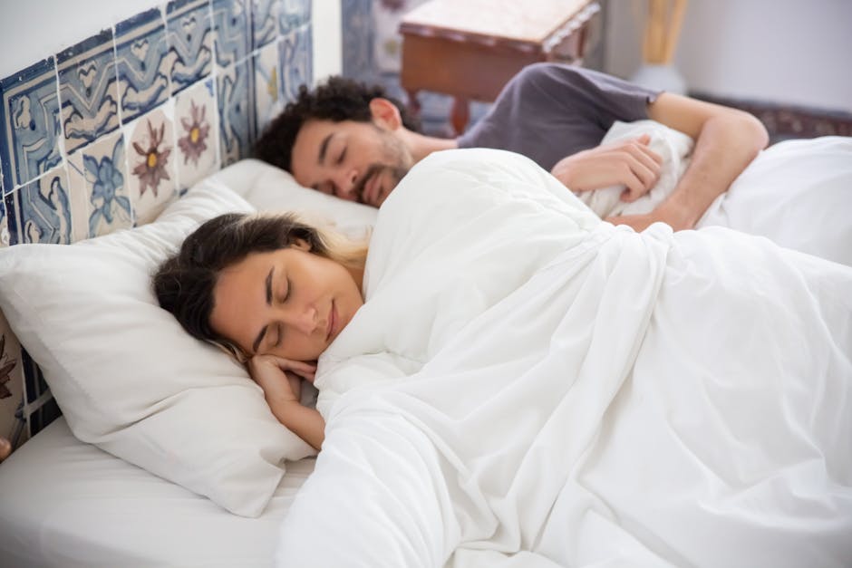 A serene image of a couple sleeping together in a cozy bedroom, capturing tranquility and comfort.