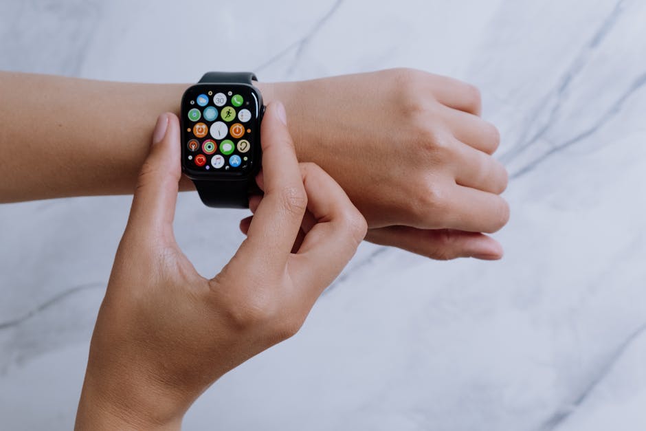 Close-up of hands interacting with a smartwatch on a marble surface, embodying modern digital connectivity.