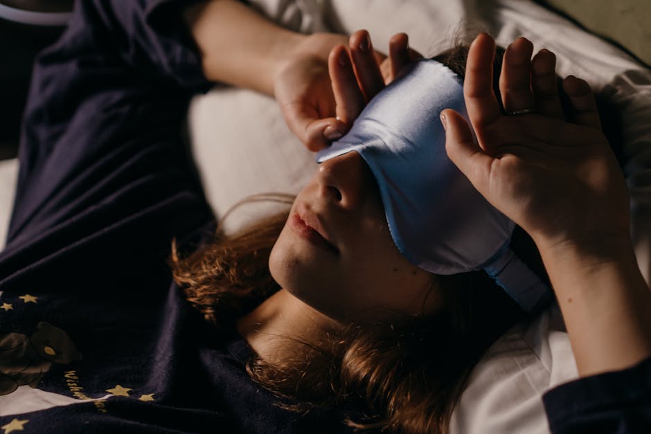 A woman resting at home wearing a sleep mask for a cozy afternoon nap.